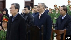 From left, Nguyen Bac Son, Hoang Duy Quang, Le Nam Tra and Truong Minh Tuan stand for the verdicts at their trial in Hanoi, Vietnam, Dec. 28, 2019. Son was sentenced to life in prison in a corruption case that saw the others receive lengthy prison time.