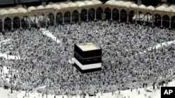 FILE - Muslim pilgrims prepare themselves for Friday prayers in front of the Kaaba, Islam's holiest shrine, at the Grand Mosque in the Muslim holy city of Mecca, Saudi Arabia, Sept. 9, 2016.