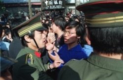 A Beijing University student leader argues with a policeman about the students' right to march as they are told not to march when emerging from their campus in Beijing, China, on April 27, 1989.