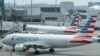 Penumpang American Airlines bersiap untuk keberangkatan di dekat terminal di Bandara Internasional Boston Logan, di Boston. (Foto: AP)