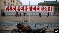 FILE - A propaganda billboard, which reads "Forward to the Ultimate Victory" in Korean is seen on display in central Kaesong, North Korea.