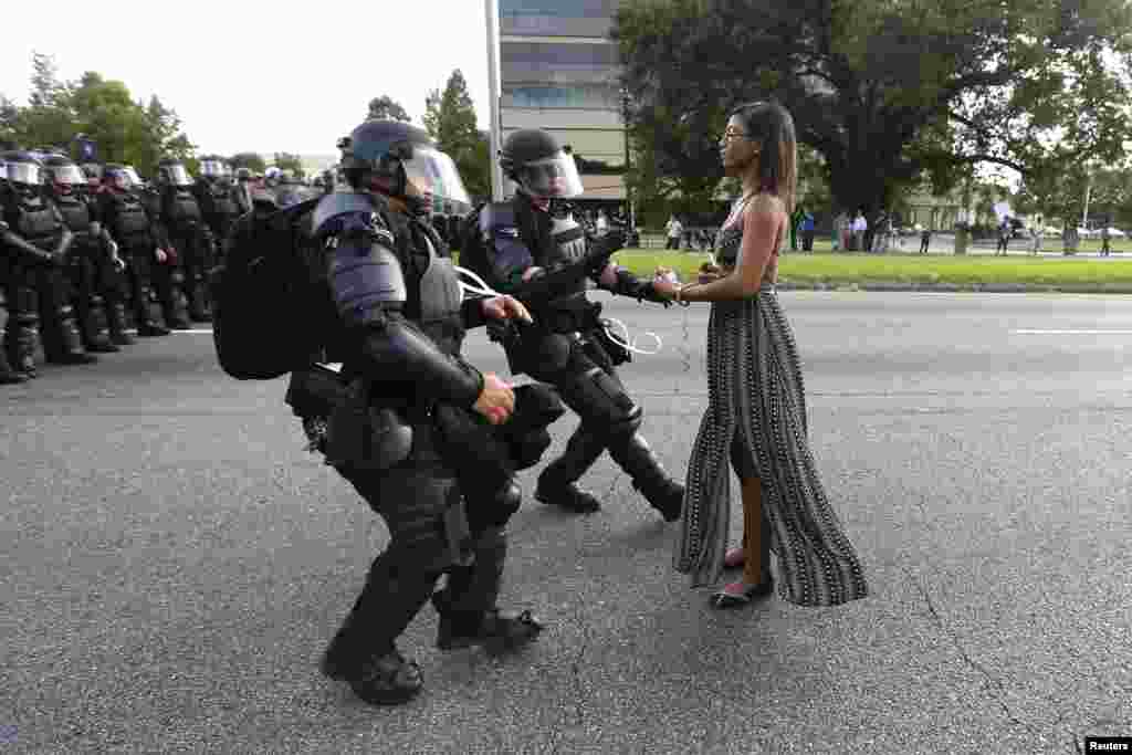A demonstrator protesting the shooting death of Alton Sterling is detained by law enforcement near the headquarters of the Baton Rouge Police Department in Baton Rouge, Louisiana, July 9, 2016.
