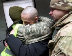 A Ukrainian citizen is welcomed upon his arrival following the exchange of prisoners of war (POWs) between Ukraine and the separatist republics near the Mayorsk crossing point in Donetsk region, Dec. 29, 2019.