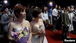 Gay and lesbian newlyweds attend a mass wedding banquet, one day after same-sex marriage officially became legal, in Taipei, Taiwan May 25, 2019. REUTERS/Tyrone Siu