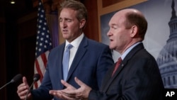 FILE: Sen. Jeff Flake, R-Ariz. (L) and Sen. Chris Coons, D-Del.