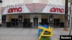 FILE - Deckchairs sit stacked outside a closed movie theater during the global outbreak of coronavirus (COVID-19) in Santa Monica, California, March 16, 2020.
