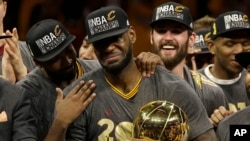 Cleveland Cavaliers forward LeBron James, center, celebrates with teammates after Game 7 of basketball's NBA Finals against the Golden State Warriors in Oakland, Calif., Sunday, June 19, 2016.