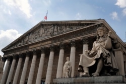 FILE - The statue of French statesman Jean-Baptiste Colbert, who served as Finance minister from 1661 until his death in 1683 under the rule of King Louis XIV, sits in front of the French National Assembly in Paris, June 10, 2020.