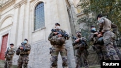 French soldiers, part of France's national security alert system "Sentinelle", patrol near the Cathedral in Arras as France has raised the security alert for French territory to the highest level after the knife attack in the city of Nice, France.