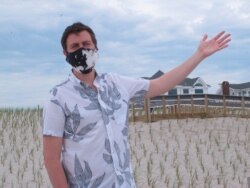Point Pleasant Beach N.J. Mayor Paul Kanitra gestures while speaking to a reporter during an interview on the beach in his town, May 15, 2020 on the first day it opened during the coronavirus outbreak.