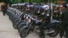 Cambodian military police officers stand by with their motorcycles at Stung Meanchey where Prime Minister Hun Sen made his first public appearance since Sunday's election, in Phnom Penh, July 31, 2013.