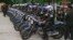 Cambodian military police officers stand by with their motorcycles at Stung Meanchey where Prime Minister Hun Sen made his first public appearance since Sunday's election, in Phnom Penh, July 31, 2013.