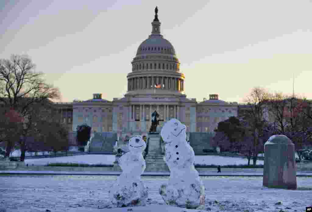 Snowmen sit in front of the Capitol in Washington, D.C., Jan. 3, 2014, after a winter snow storm in the nation's capital. 