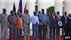 The seven detainees from South Sudan, shown here with Kenyan President Uhuru Kenyatta, after they were released to his custody, will be a third party at peace talks for South Suidan, along with pro- and anti-government negotiators. 