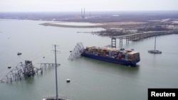 Aerial view of the Dali cargo vessel which crashed into the Francis Scott Key Bridge, causing it to collapse in Baltimore, Maryland, March 26, 2024.