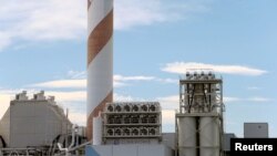 FILE - A facility made by Climeworks AG to capture CO2 from the air is seen on the roof of a waste incinerating plant in Hinwil, Switzerland, July 18, 2017.