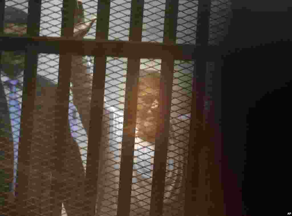 Egypt&#39;s ousted Islamist president Mohamed Morsi sits in a soundproof glass cage inside a makeshift courtroom at Egypt&rsquo;s national police academy in Cairo, April 21, 2015.