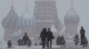 FILE - People walk in Red Square during heavy snowfall in Moscow, Russia, Jan 27, 2019.