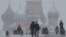FILE - People walk in Red Square during heavy snowfall in Moscow, Russia, Jan 27, 2019.