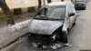 FILE - The burnt car of RFE/RL journalist Halyna Tereshchuk in is seen on a street in Lviv, western Ukraine. 