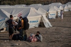 Migrants arrive at a temporary camp near Mytilene town, on the northeastern island of Lesbos, Greece, Sept. 12, 2020.