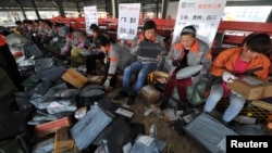 Employees sort packages at a hub of Shentong (STO) Express delivery company in Hefei, Anhui province. China's Singles' Day, which is celebrated annually on November 11, has become the world's largest online shopping day, with online shopping websites offe