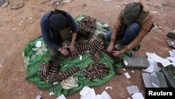 Rebel fighters arrange shells on the outskirts of the northern Syrian town of al-Bab, Syria, Jan. 26, 2017.
