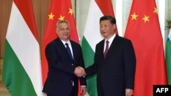 FILE - Hungarian Prime Minister Viktor Orban, left, shakes hands with Chinese President Xi Jinping during a meeting on April 25, 2019, as part of the second Belt and Road Forum in Beijing.