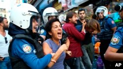 FILE - Turkish police officers arrest protesters, gathered to offer support to workers that were arrested early Saturday for protesting over labor conditions at Istanbul's new airport, in Istanbul, Sept. 15, 2018.