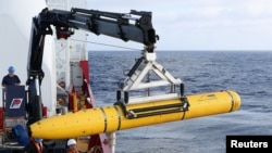Awak kapal Ocean Shield milik Dephan Australia memindahkan kapal selam robotik milik Angkatan Laut AS, Bluefin-21 untuk misi pencarian pesawat MH370 di Samudera Hindia (14/4).