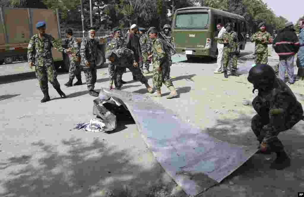 Afghanistan's National Army soldiers remove debris at the site of a suicide attack in Kabul, July 2, 2014.
