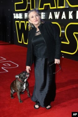 Carrie Fisher poses for photographers upon arrival at the European premiere of the film 'Star Wars: The Force Awakens ' in London, Wednesday, Dec. 16, 2015.
