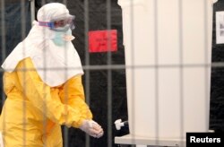 A volunteer for Doctors Without Borders learns how to handle the kind of personal protective equipment provided by some corporate donors. He’s training in Brussells Oct. 15, 2014.