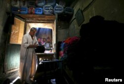 Salama Mahmoud Salama, 75, the owner of a dye workshop looks at yarns at the workshop in old Cairo, Egypt, March 17, 2016.