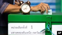 A woman casts her vote at a polling station in Bangkok, Thailand, Sunday, March 24, 2019, during Thailand's first general election since the military seized power in a 2014 coup. (AP Photo/Wason Wanichakorn)