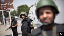 Egyptian police special forces stand guard beside an armored vehicle, protecting a bridge between Tahrir Square and Cairo University, where Muslim Brotherhood supporters have gathered, in Giza, Egypt, July 3, 2013.