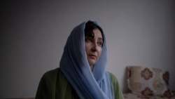 Rishmin Juyunda poses for a photograph in Kabul, Afghanistan, Oct. 22, 2021. A rights activist, she is part of an underground network determined to fight repressive Taliban policies that limit the freedoms of women.