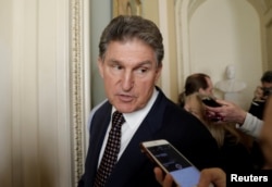 FILE - U.S. Senator Joe Manchin (D-WV) talks to reporters on Capitol Hill in Washington, U.S., Jan. 19, 2018.