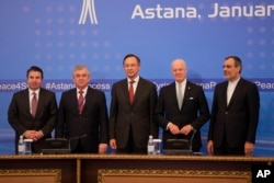 From left, Turkish Foreign Ministry Deputy Undersecretary Sedat Onal, Russia's special envoy on Syria Alexander Lavrentiev, Kazakh Foreign Minister Kairat Abdrakhmanov, UN Syria envoy Staffan de Mistura and Iran's Deputy Foreign Minister Hossein Jaber Ansari pose for a photo after the final statement following the talks on Syrian peace in Astana, Kazakhstan, Jan. 24, 2017.