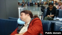 A passenger rests during a long layover in Houston, Texas.