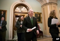 FILE - Senate Majority Leader Mitch McConnell, R-Ky., leaves the chamber after announcing an agreement in the Senate on a two-year, almost $400 billion budget deal, at the Capitol in Washington, Feb. 7, 2018.