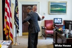 President Barack Obama celebrates the Supreme Court ruling on Affordable Care Act (ACA) subsidies, with Chief of Staff Denis McDonough in the Outer Oval Office. June 25, 2015. (Official White House Photo by Pete Souza)