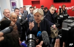 FILE - French far-right leader and presidential candidate Marine le Pen answers reporters questions at her campaign headquarters, Nov.16, 2016, in Paris. Le Pen also faces allegations of improper use of funds.