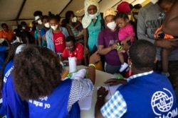 Haitians who were deported from the U.S. border with Mexico are attended by members of the IOM UN Migration organization before they get tested for COVID-19 at Toussaint Louverture International Airport in Port-au-Prince, Haiti, Monday, Sept. 20, 2021. (AP)