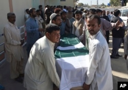 People carry the coffin of a victim of an overnight attack on a police academy, in Quetta, Pakistan, Oct. 25, 2016.