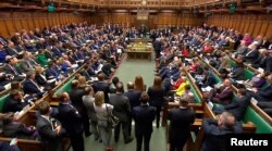 FILE - Britain's Prime Minister Theresa May addresses the House of Commons, in London, March 14, 2018.