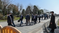 Chinese officials depart following a meeting with the World Health Organization (WHO) team investigating the origins of the Covid-19 pandemic at the Hilton Wuhan Optics Valley Hotel in Wuhan, China’s central Hubei province on January 29, 2021. (AFP)
