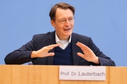 German Health Minister Karl Lauterbach attends a news conference on the COVID-19 pandemic in Berlin, Germany, Jan. 28, 2022.