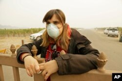 Angela Pardo works at the main entrance gate to the Gundlach Bundschu winery, Oct. 10, 2017, in Sonoma, California.