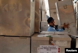 FILE - A worker unloads ballot boxes for the upcoming Indonesian presidential elections in Sidoarjo, near Surabaya, East Java, July 7, 2014.